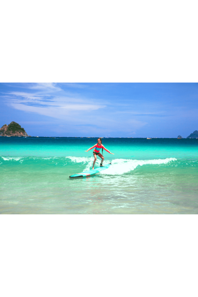 woman surfing wave at women's surf camp